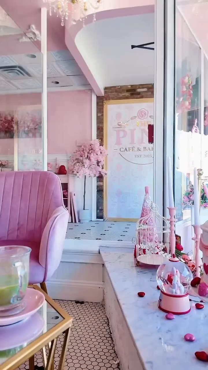 The Pink Cafe interior with pink velvet seating and cherry blossom decor