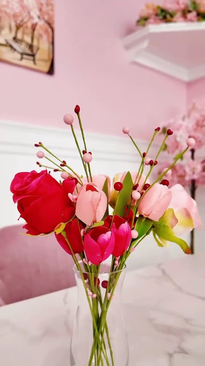 Fresh roses and tulips in a vase on a marble table